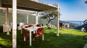 a table and chairs sitting under a pergola at Looky Hotel in Sori