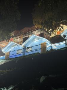 a building with lights on it at night at Shivpuri Ghumakkad Resort in Shivpuri +3 photos