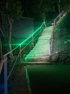 a stairway with green lights on it at night at Shivpuri Ghumakkad Resort in Shivpuri