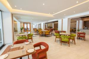 a restaurant with tables and chairs and a cafeteria at Luxus Naran in Naran