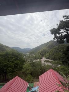 a view of a valley with mountains and trees at Shivpuri Ghumakkad Resort in Shivpuri