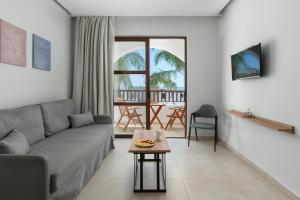 a living room with a couch and a table at Costa Lindia Blue Star - Adults Only in Lartos