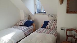 a small room with two beds and a window at Traditional fisherman cottage in Yport