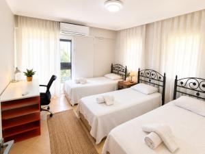 a hotel room with two beds and a desk and a desk at Villa Elma in Kuşadası +35 photos