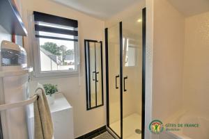 a bathroom with a shower with a glass door at Les flots du bono in Le Bono +22 photos