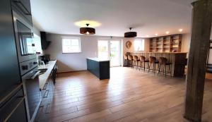 a kitchen with a counter and chairs in a room at Le moulin de la hamelle in Yoncq