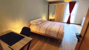 a bedroom with a bed and a table and a window at Le moulin de la hamelle in Yoncq +42 photos