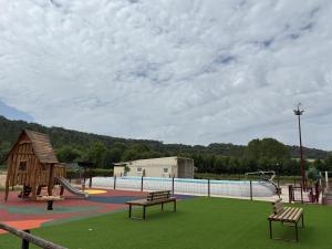 a park with a playground with a pool and a slide at Le moulin de la hamelle in Yoncq
