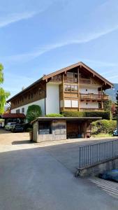 a building with a parking lot in front of it at FeWo Rottachglück in Tegernsee +8 photos