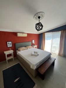 a bedroom with a large bed and red walls at Buena Vista Hotel&Restaurant in Marmaris