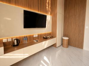 a living room with a tv and a counter with at Lombok Hidden Villa in Tetebatu