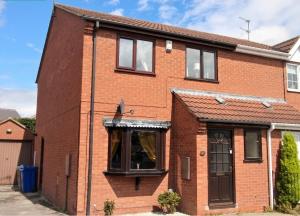 an image of a brick house at 3 Bed Semi - Sleeps 5 - Private Garden & Parking - Quiet Cul De Sac Location - Dog Friendly - Fast Wifi - Close to Motorway Access in Doncaster