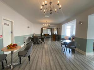 a dining room with a table and chairs and a chandelier at 262 Ocean Manor in Blackpool