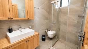 a bathroom with a sink and a shower at Han Villa in Kaş