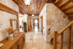a hallway in a home with a stone wall at Han Villa in Kaş