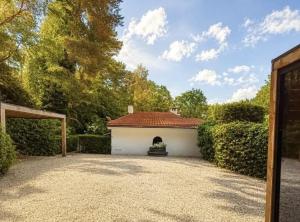 a white garage with a red roof at The Park Retreat in Schoten