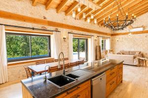 a kitchen with a sink and a living room at Han Villa in Kaş