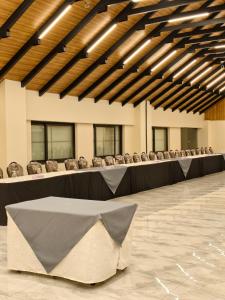 a large room with tables and chairs in it at Luxus Naran in Naran