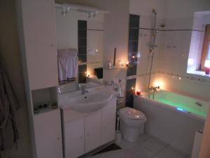 a bathroom with a sink and a tub and a toilet at Les Gîtes des Portes de Bretagne in La Chapelle-Saint-Aubert +51 photos