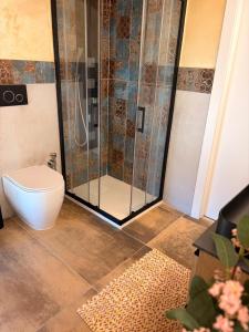 a bathroom with a shower with a toilet and a sink at Casa Van Gogh Catania in Catania