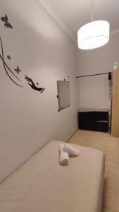 a white room with a bed and a room with a window at El Faro-Beach in Cullera