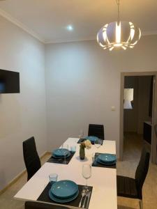 a dining room with a table with blue plates on it at El Faro-Beach in Cullera +13 photos