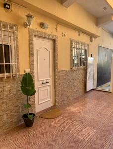 a room with a door and a potted plant at El Faro-Beach in Cullera