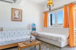 a bedroom with two beds and a window at Agnadi Apartment in Serifos Chora