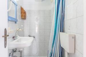 a bathroom with a sink and a toilet at Agnadi Apartment in Serifos Chora