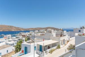 a view of a town with white buildings and the ocean at Agnadi Apartment in Serifos Chora