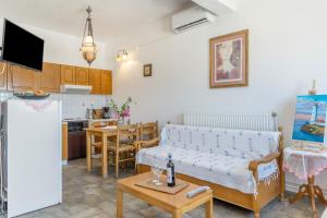 a living room with a couch and a table at Agnadi Apartment in Serifos Chora