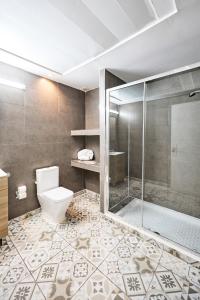a bathroom with a toilet and a shower at Hostal Sunset Ibiza in San Antonio