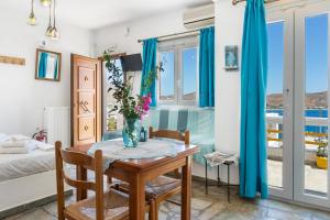 a room with a table with a vase of flowers on it at Agnadi Studio in Serifos Chora