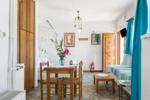 a room with a table and chairs and a bed at Agnadi Studio in Serifos Chora +23 photos