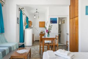 a kitchen and living room with a table and a refrigerator at Agnadi Studio in Serifos Chora