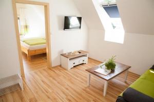 a small living room with a bed and a table at Obst- und Weinbauernhof BERNHARD in Leutschach