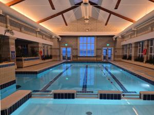 a large swimming pool in a building at Connemara Coast Hotel in Furbo