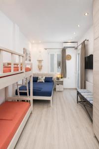 a bedroom with two bunk beds and a living room at Bella Vista Mare 2 in Moutsoúna +40 photos