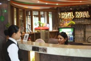 a man and a woman sitting at a bar at Hotel Royal Sen in Lālbhitti