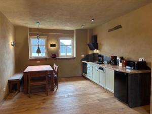 a kitchen with a table and a dining room at Brühlbach-Blick in Morbach