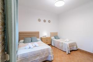 a bedroom with two beds with towels on them at Casa Rural Villa Manantial in La Puebla de Cazalla +41 photos
