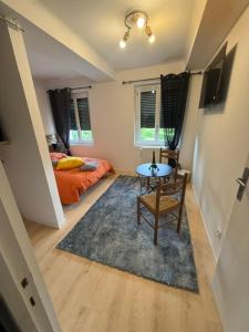 a small room with a table and a bed at la Pause Pyrénées in Maubourguet