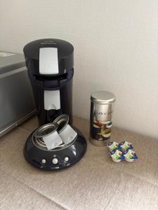 a coffee maker sitting next to a trash can at Green View Apartment in Wülfrath