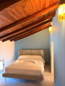 a bed in a bedroom with a wooden ceiling at Casa Van Gogh Catania in Catania +7 photos