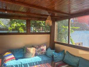a blue couch in a room with windows at Dar Bleu Pearl in Chefchaouen