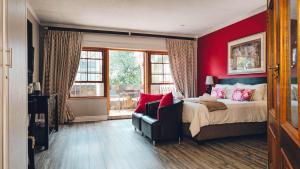 a bedroom with a bed and a chair and window at 314 on Clark Guest House in Pretoria