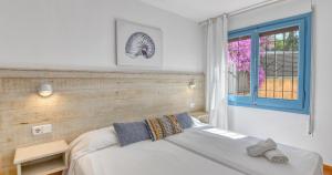 a bedroom with a white bed and a window at Penyagolosa in Calella de Palafrugell +35 photos