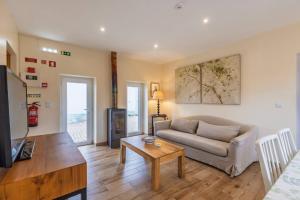 a living room with a couch and a table at 199 - Quinta dos Carvalhos in Castelo Branco