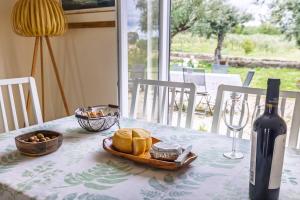 a table with a plate of bread and a bottle of wine at 199 - Quinta dos Carvalhos in Castelo Branco +83 photos