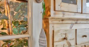 a close up of a wooden cabinet next to a window at Exclusive Position Front Line Apartments Calau in Calella de Palafrugell +24 photos